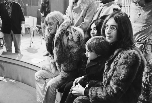 Rolling Stones guitarist Brian Jones, artist Yoko Ono and her husband, Beatles guitarist John Lennon, with his son Julian on his lap, at Internel Studios in Stonebridge Park, Wembley, where they watched some of the circus acts who will appear in a television spectacular planned by the Rolling Stones, 'The Rolling Stones' Rock 'n' Roll Circus,' England, 10th December 1968. (Photo by David Cairns/Express/Getty Images)